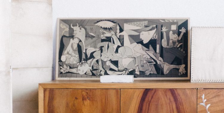 Guernica print sitting on a shelf
