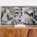 Guernica print sitting on a shelf